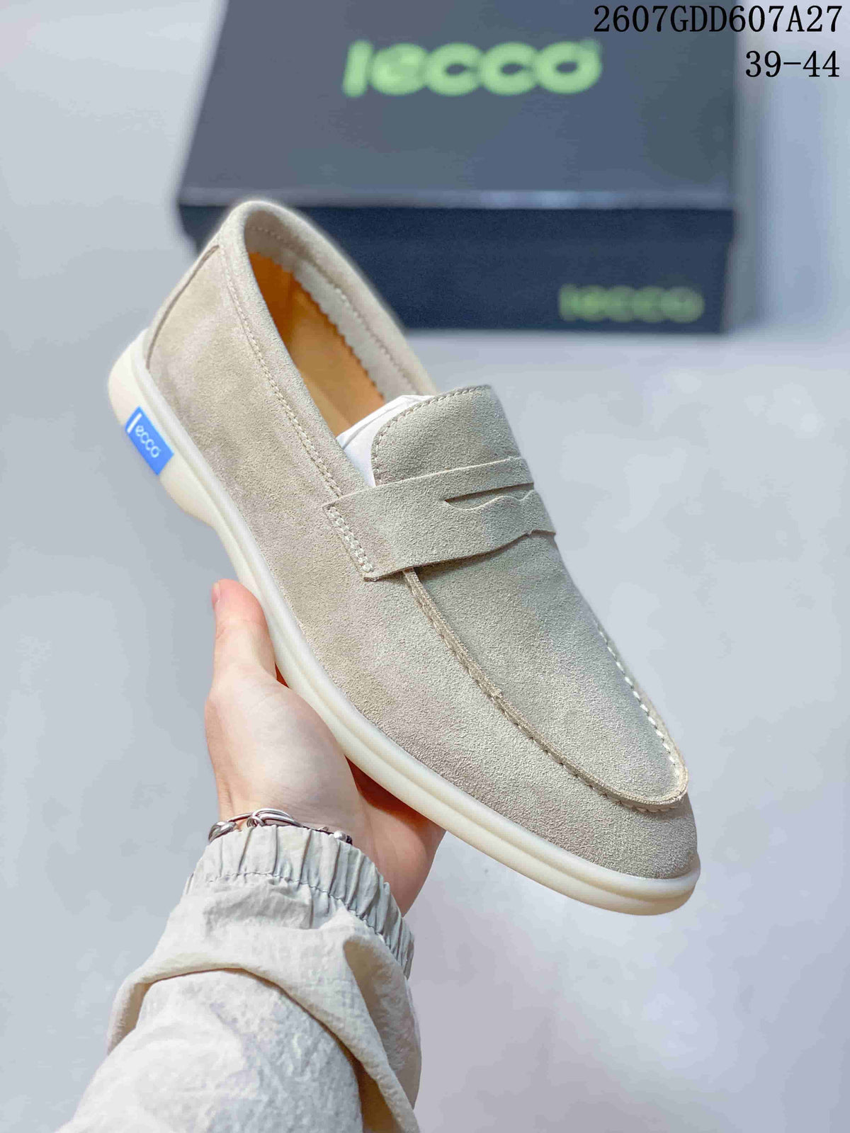 Angled side view of a light beige ECCO loafer showing the slip-on opening, vamp strap, side label, and flat sole.