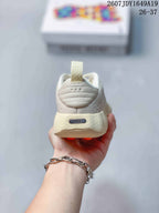 Rear view of the cream sneaker showing the heel pull tab, layered heel design, and Nike branding.