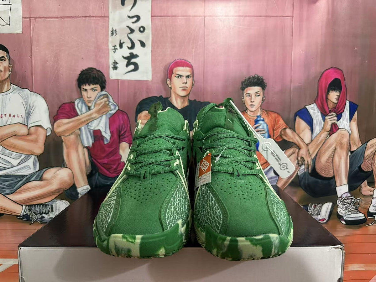 Front view showing green laces, perforated uppers, and patterned outsole edges.