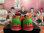 Rear view showing green heel panels on red Nike Kobe basketball shoes