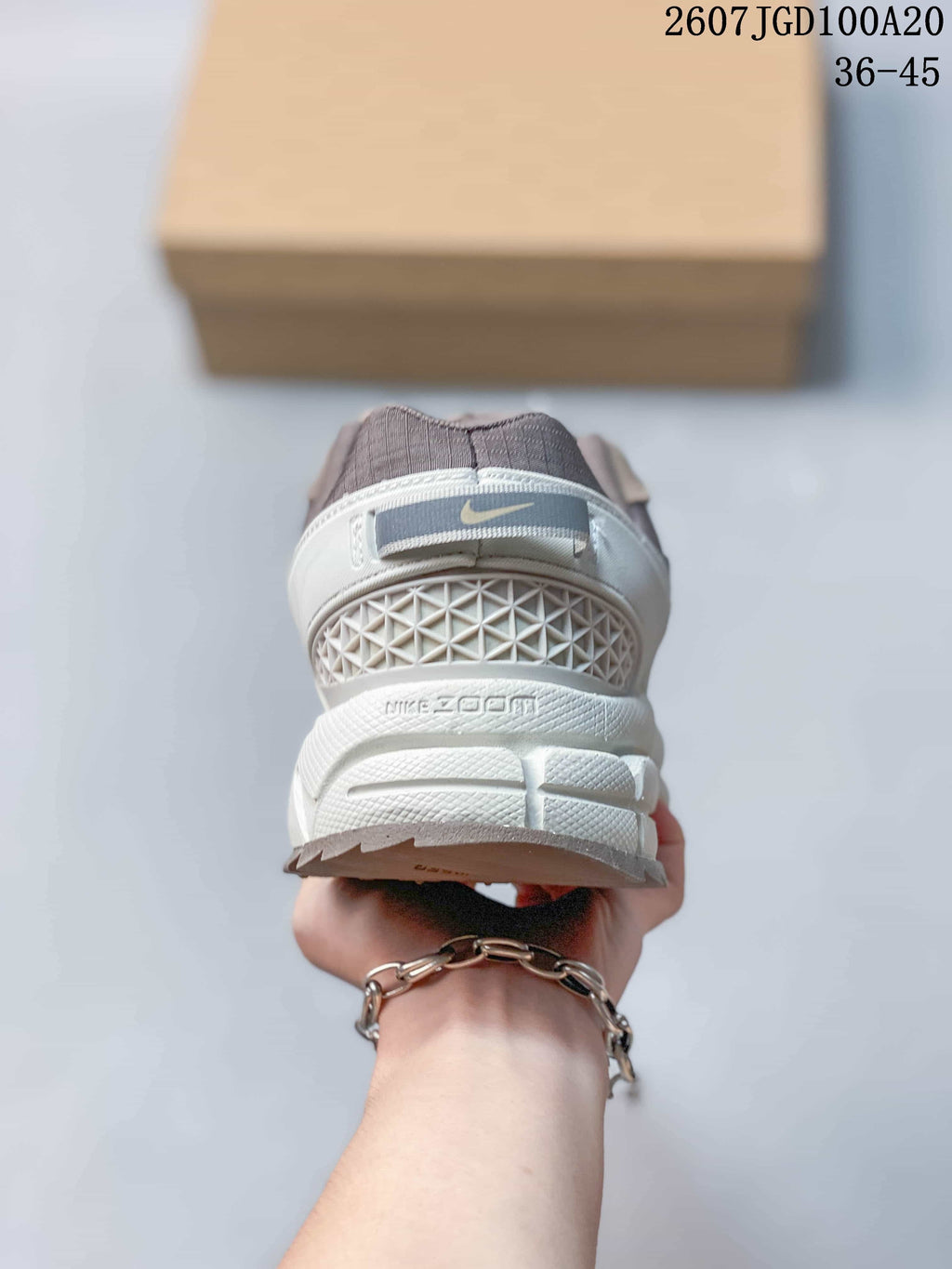 Rear view showing the Nike heel logo, textured heel structure, and sculpted white midsole.