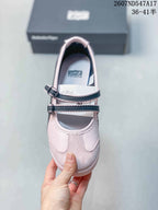 Top view showing the pale pink upper, rounded toe, two dark-trimmed buckle straps, and insoles.