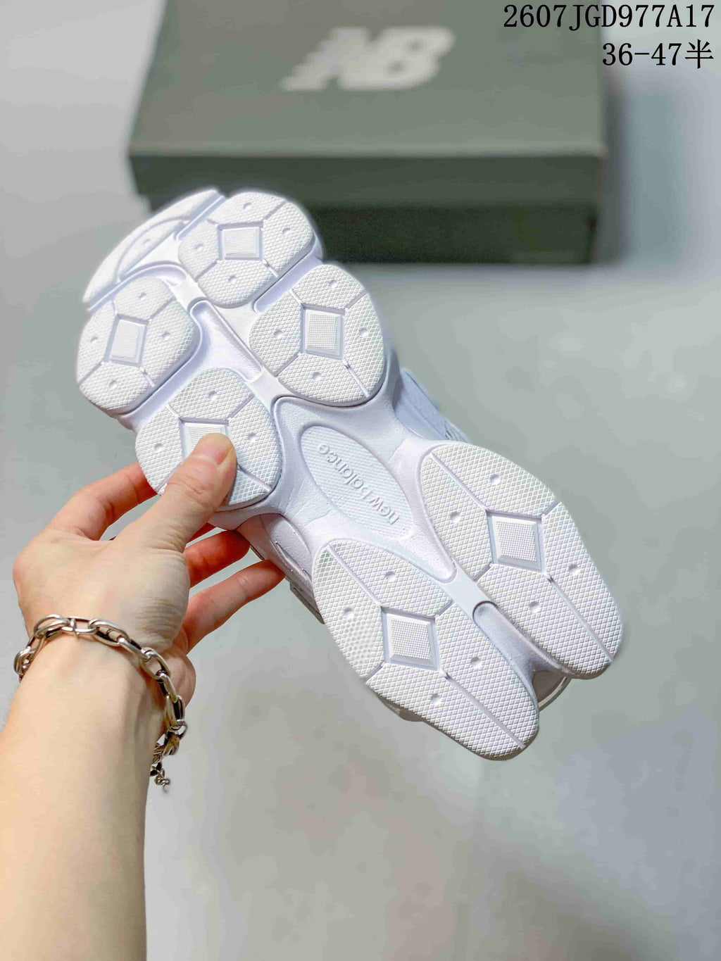 Underside view of the white sneakers showing the segmented textured outsole and ABZORB marking.