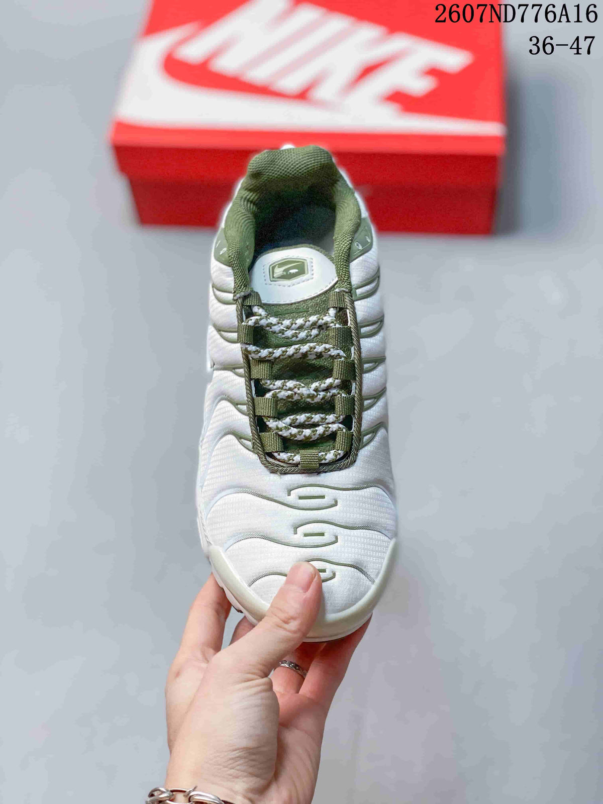 Top view of the sneaker showing the white upper, green lace supports, patterned laces, and padded collar.