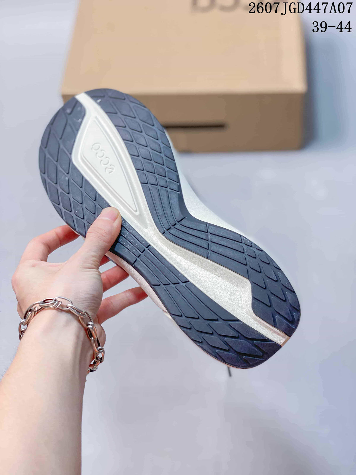 Close-up of the sneaker outsole showing a dark patterned rubber tread and contrasting white midsole.