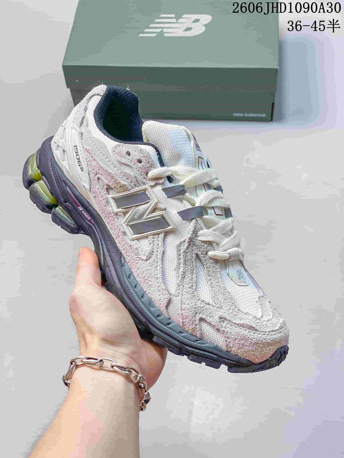 Pale gray and pink New Balance M1906R sneaker with a segmented sole