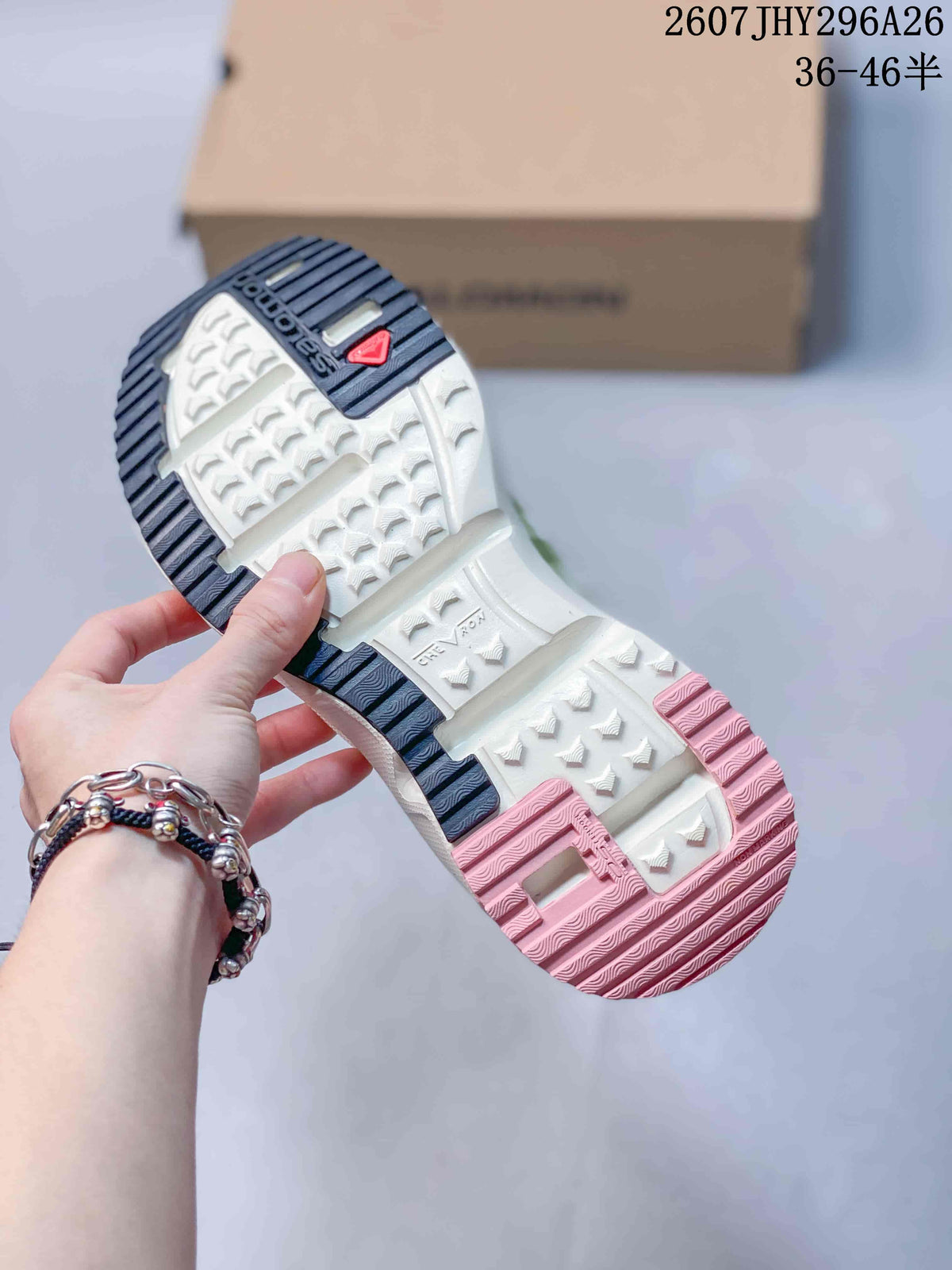 Underside view of a Salomon slip-on showing the segmented white outsole, dark heel tread and pink forefoot tread.