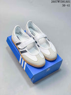 Pair of white adidas Samba Jane sneakers with grey stripes, Mary Jane straps and gum-colored soles