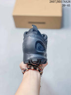 Rear view of the dark gray sneaker showing the padded heel area, pull tab, and outsole lugs.