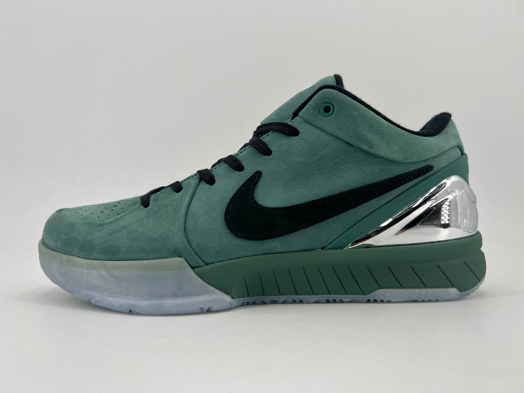 Side profile of the green low-top basketball shoe with black Swoosh