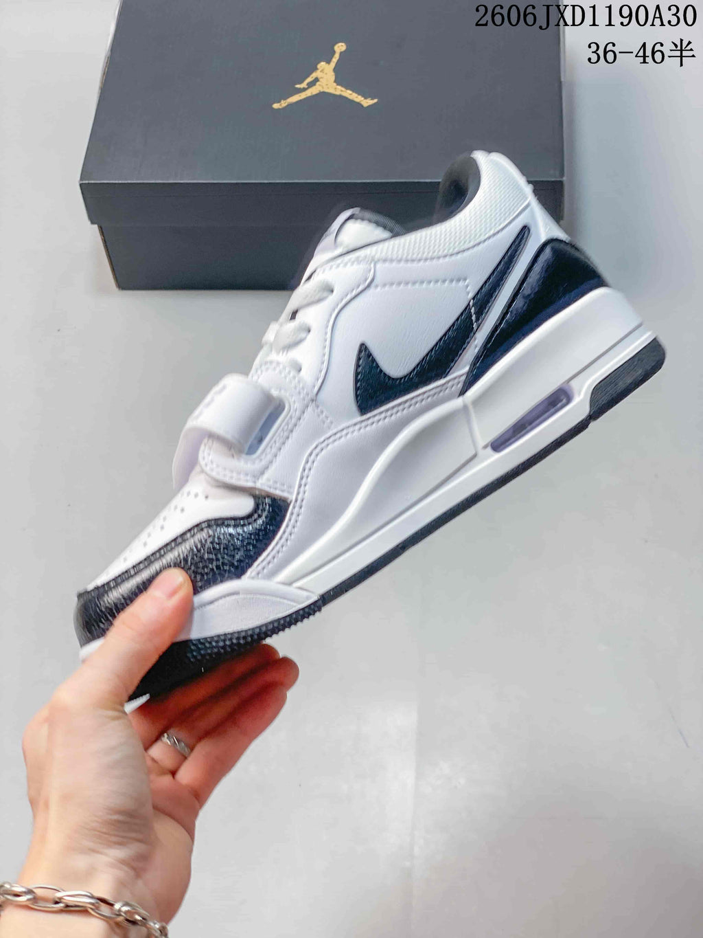 Side view showing the strap and dark overlays on a Jordan Legacy 312 Low