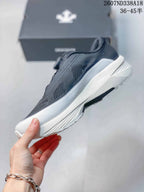 Side profile of the low-top sneaker showing the mesh upper, layered panels, and white midsole.