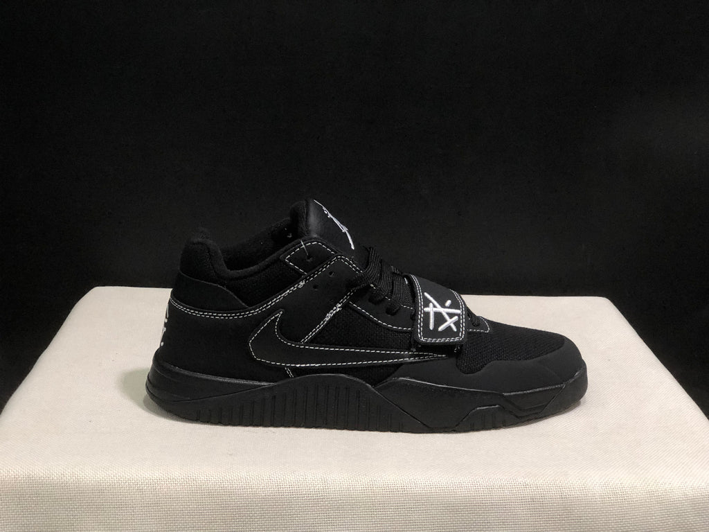 Lateral close view of one black sneaker showing the forefoot strap, Swoosh and textured midsole.