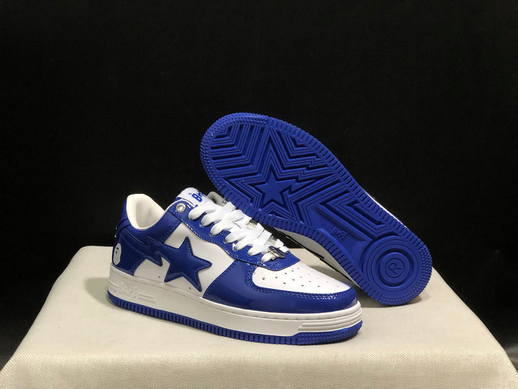 Angled view of the sneakers with one shoe lifted to show the blue textured outsole and star tread pattern.