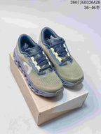 Pair of olive and gray On Cloudmonster 3 sneakers displayed on a shoebox, with the JGD326A26 style code and size range visible at the top.