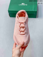 Top view of a pink lace-up sneaker with a perforated patterned upper