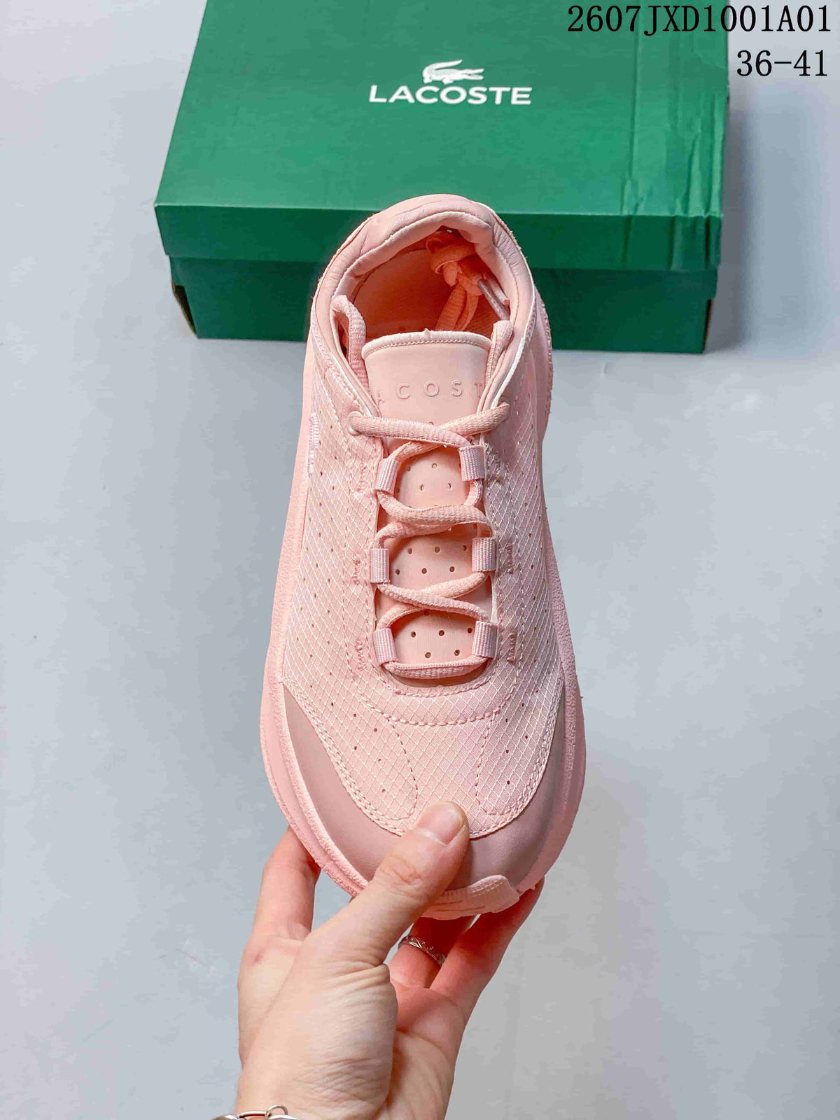 Top view of a pink lace-up sneaker with a perforated patterned upper