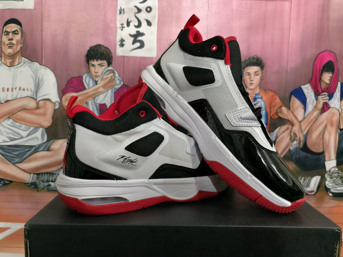 Angled view of a pair of white, black, and red Jordan Flight basketball sneakers