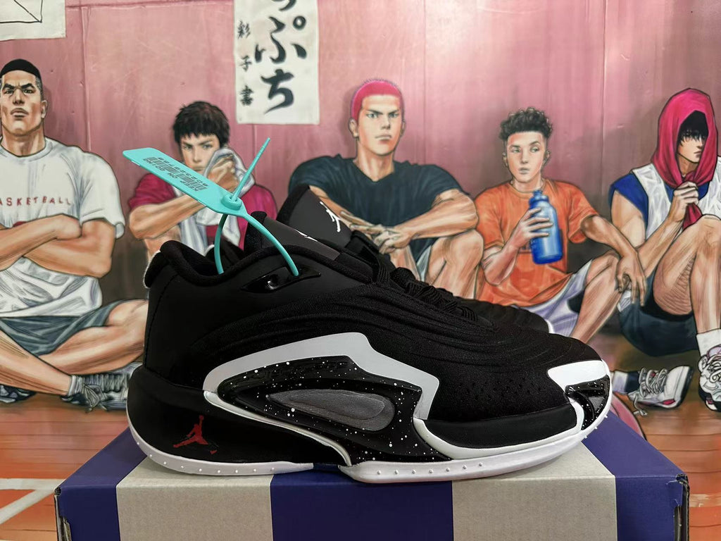 Side view of a black Jordan basketball shoe with white and red details