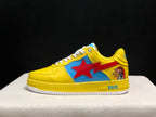 Side profile of a yellow low-top sneaker showing the blue side panel, red star graphic, heel character artwork, and white outsole.