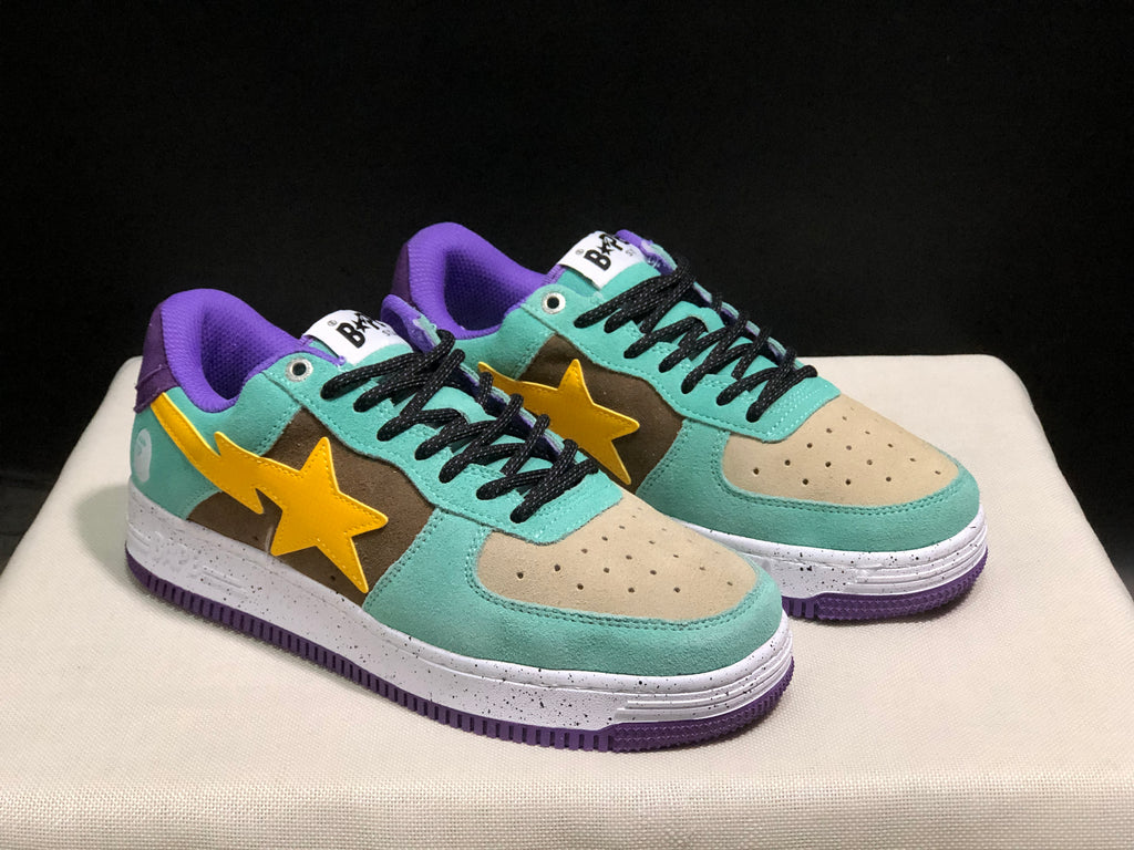 Front three-quarter view of the pair highlighting the beige perforated toe panels, black laces, and contrasting multicolor upper.