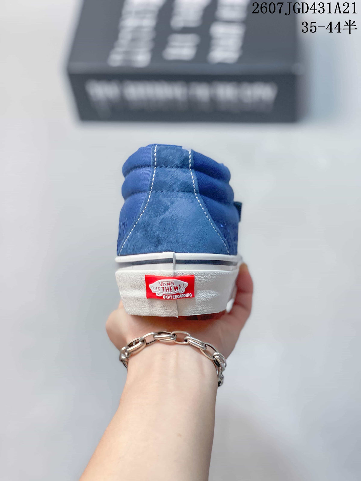 Rear view of the blue sneaker showing contrast stitching, padded collar, and Vans heel label.