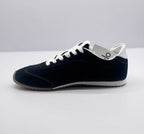 Opposite side view of the black low-top sneaker with white laces and a white midsole.