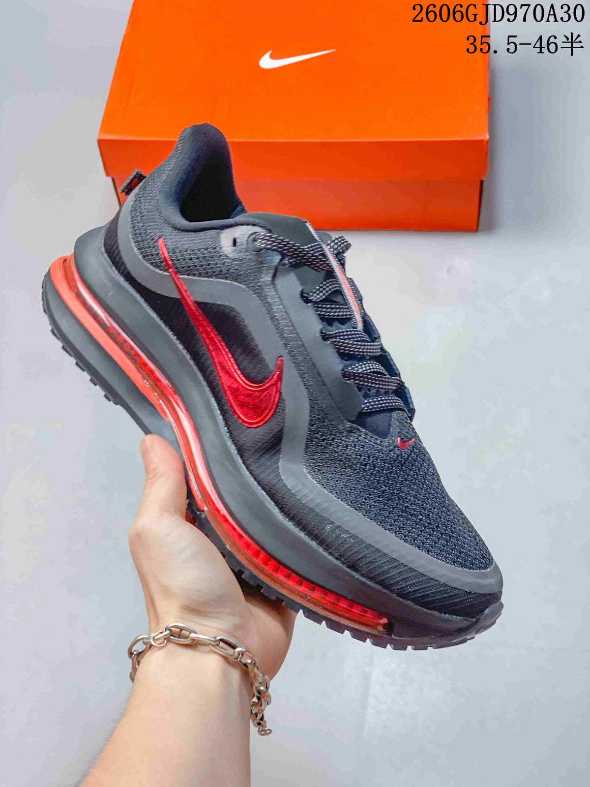 Dark gray Nike Air Zoom Pegasus Premium sneaker with red accents and a visible midsole unit.