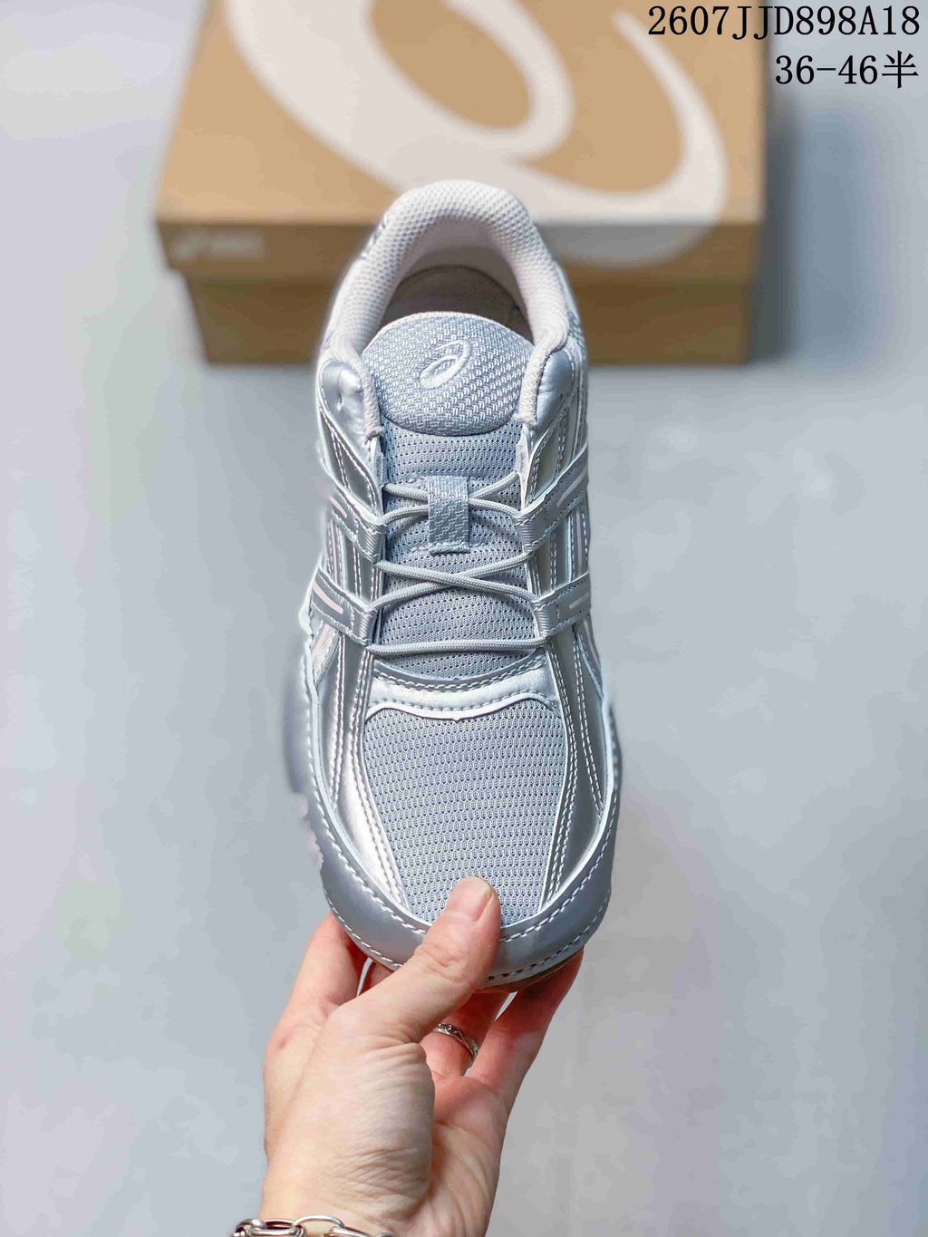 Top view showing the gray mesh toe box, tongue, laces, and silver overlays.