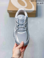 Top view showing the gray mesh toe box, tongue, laces, and silver overlays.