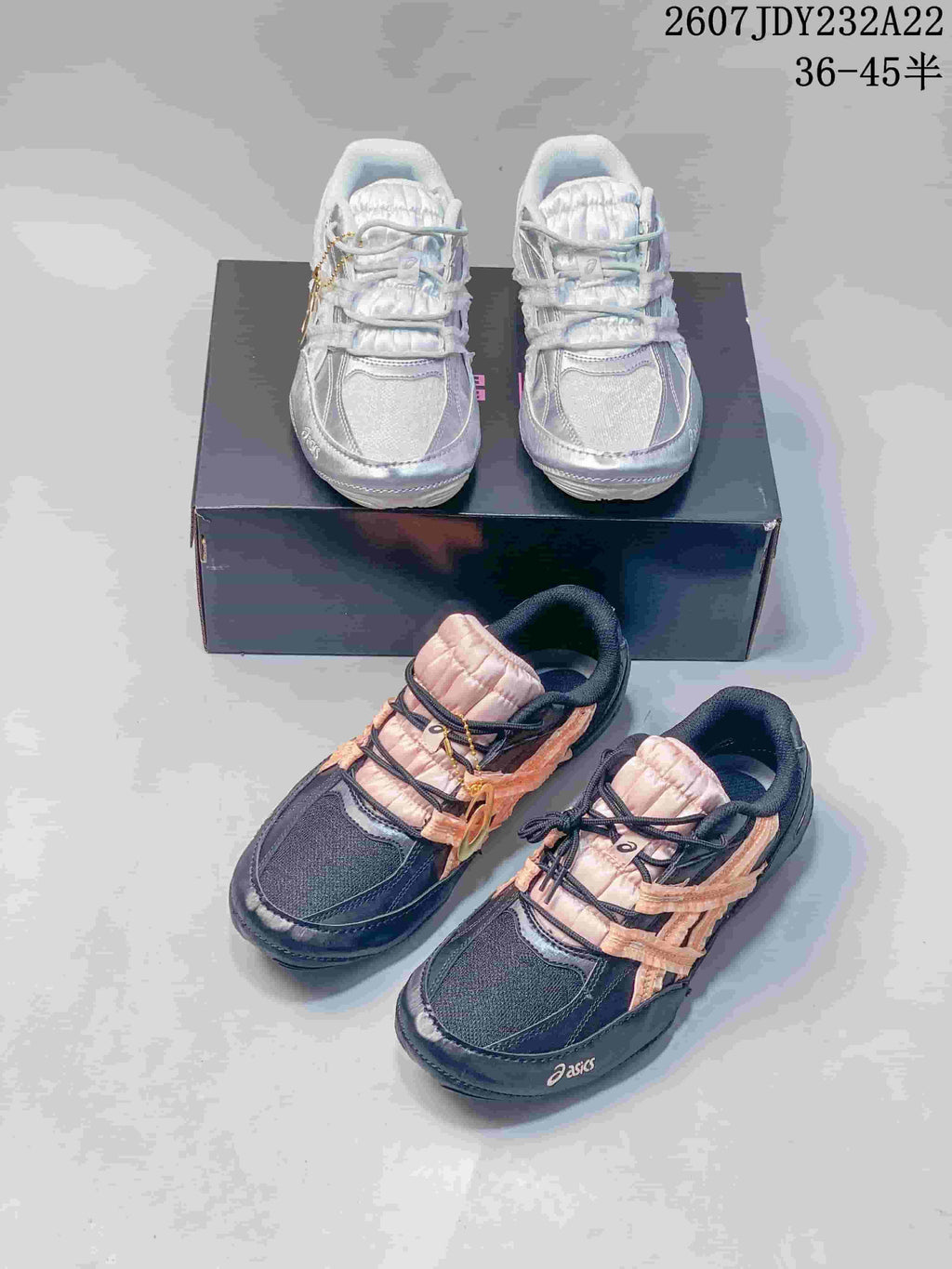 Both black-and-peach and white colorways of the ASICS Hypersync sneakers shown together.
