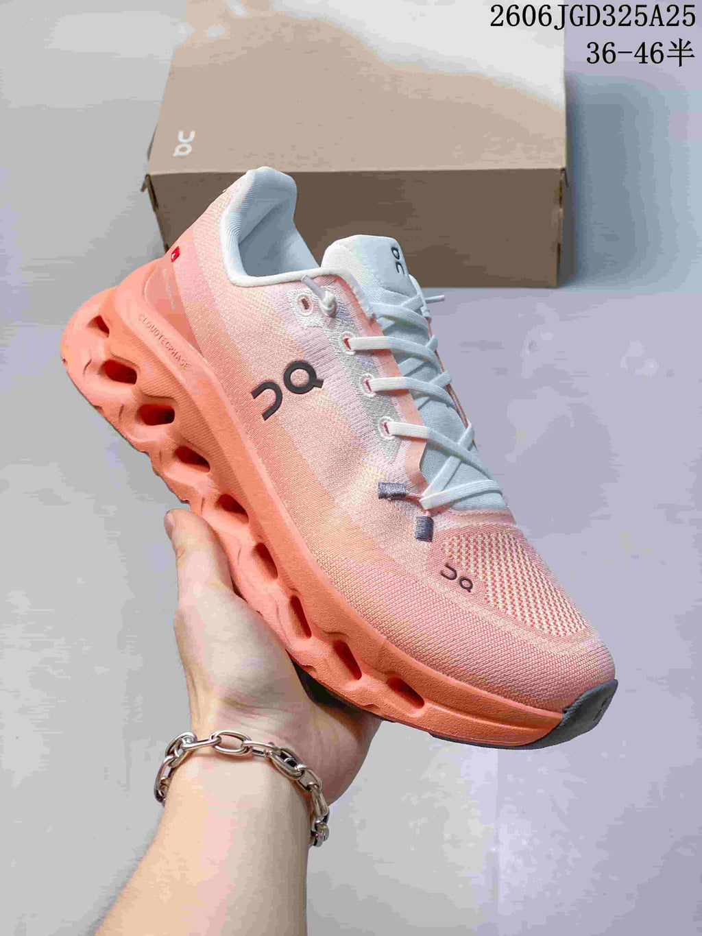 Angled side view of the pink and coral On Cloudsurfer sneaker showing the upper, branding, lace system, and sculpted sole.