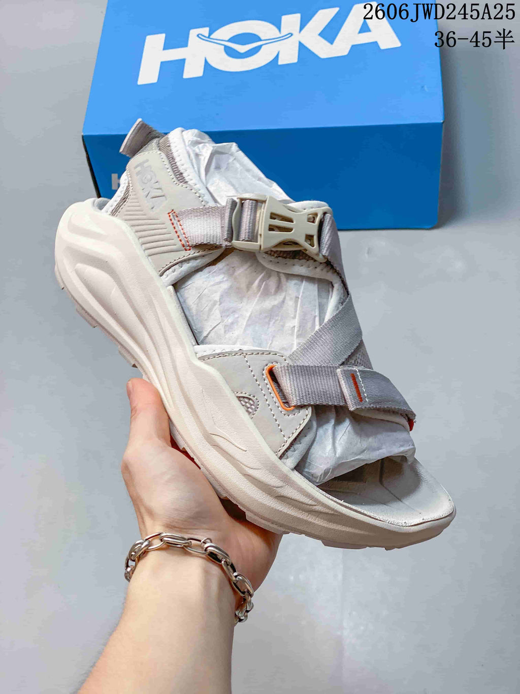 Light gray HOKA Infini Hike TC sandal with adjustable straps and contrasting accents