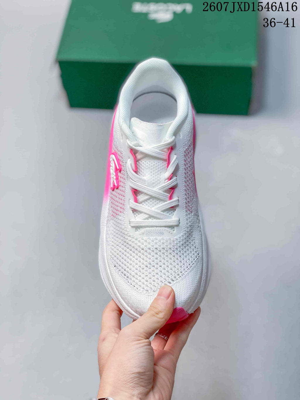 Top view of the white lace-up sneaker with pink details around the eyelets.