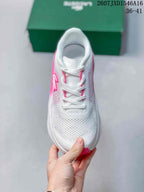 Top view of the white lace-up sneaker with pink details around the eyelets.