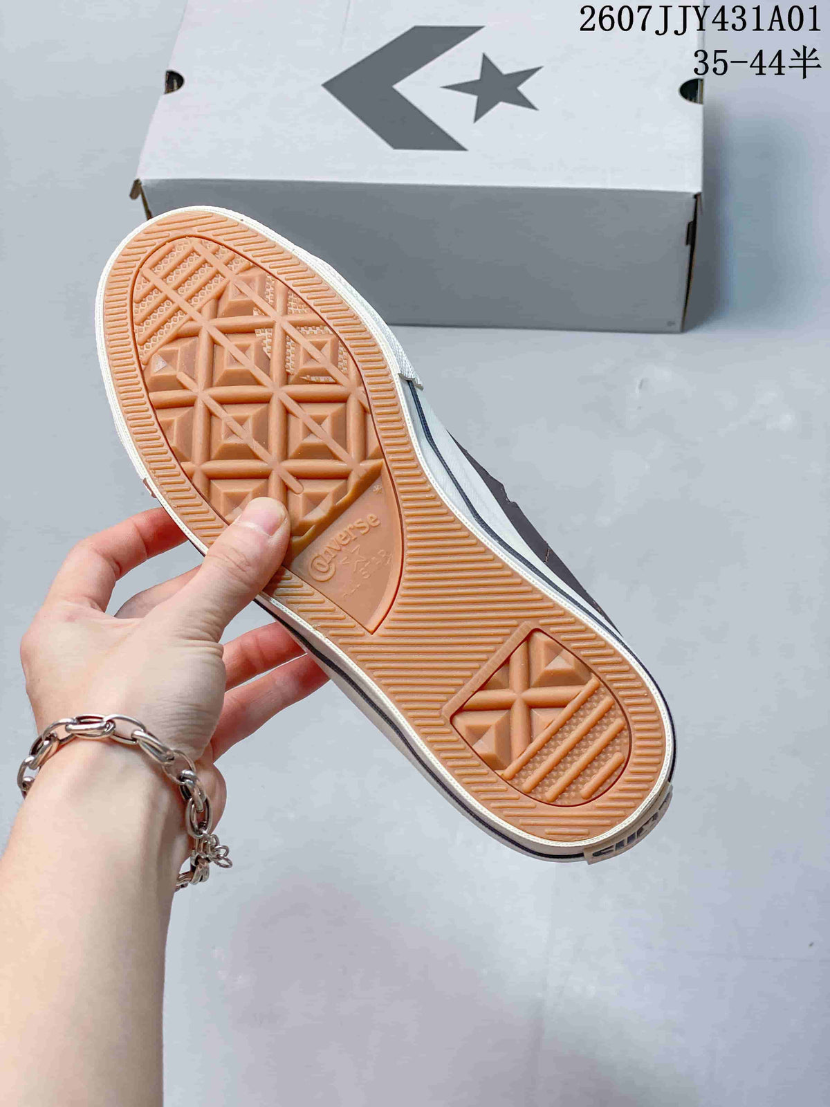 Underside of a Converse sneaker showing its textured gum-colored tread