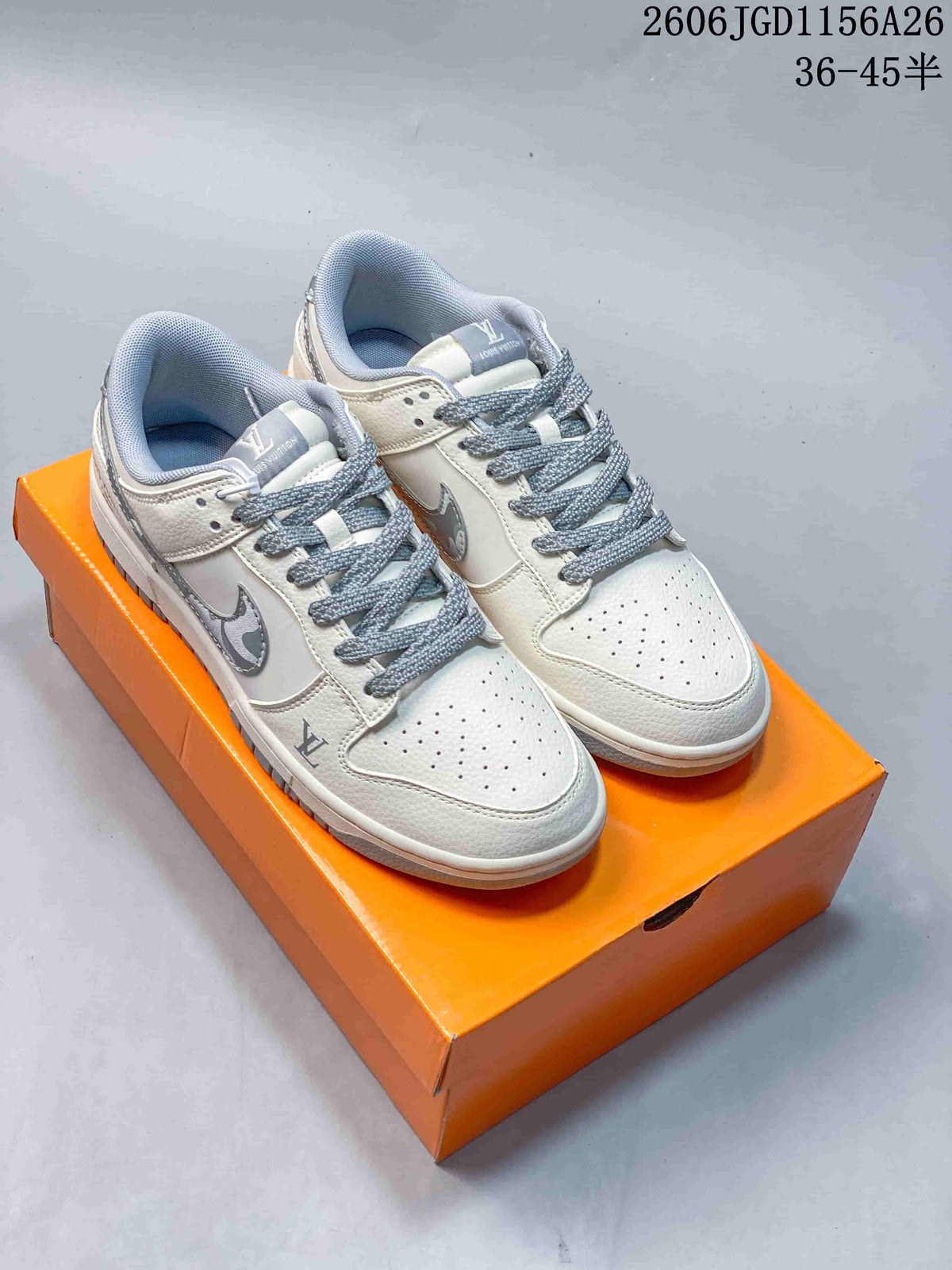 Pair of white low-top sneakers with gray accents and patterned side panels.