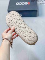 Close-up of the light-colored rubber outsole showing its rounded textured tread pattern.