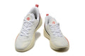Pair of white Nike LeBron basketball shoes with red accents, shown from the front