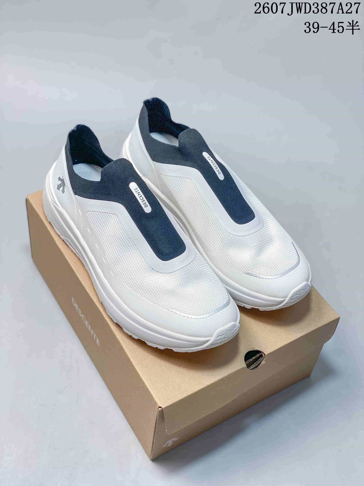 Pair of white and navy Descente slip-on sneakers displayed on a shoebox.