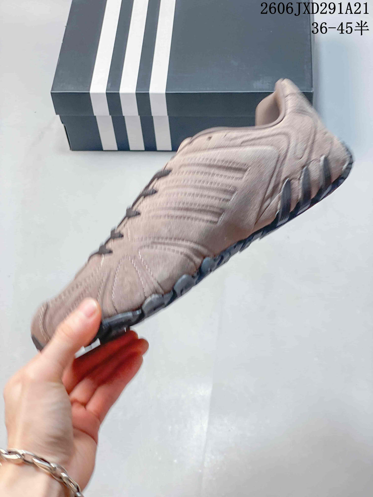 Side profile showing the layered upper panels, curved stitching and low-profile sole.