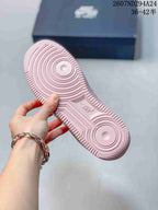 Close view of the soft pink outsole showing circular traction grooves and Nike branding.