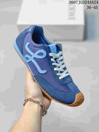 Angled side view of the blue Loewe sneaker showing the light-blue side motif, layered upper, white laces, and gum-colored outsole.