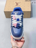 Top view of the blue sneaker showing the rounded toe, white laces, and pink and blue decorative lace charms.