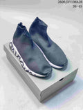 Pair of dark gray Balenciaga sock-style sneakers with white sculpted midsoles displayed on a shoebox; style code 2606JDY196A26 and size range 36–45 are visible.