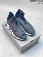 Pair of dark gray Balenciaga sock-style sneakers with white sculpted midsoles displayed on a shoebox; style code 2606JDY196A26 and size range 36–45 are visible.