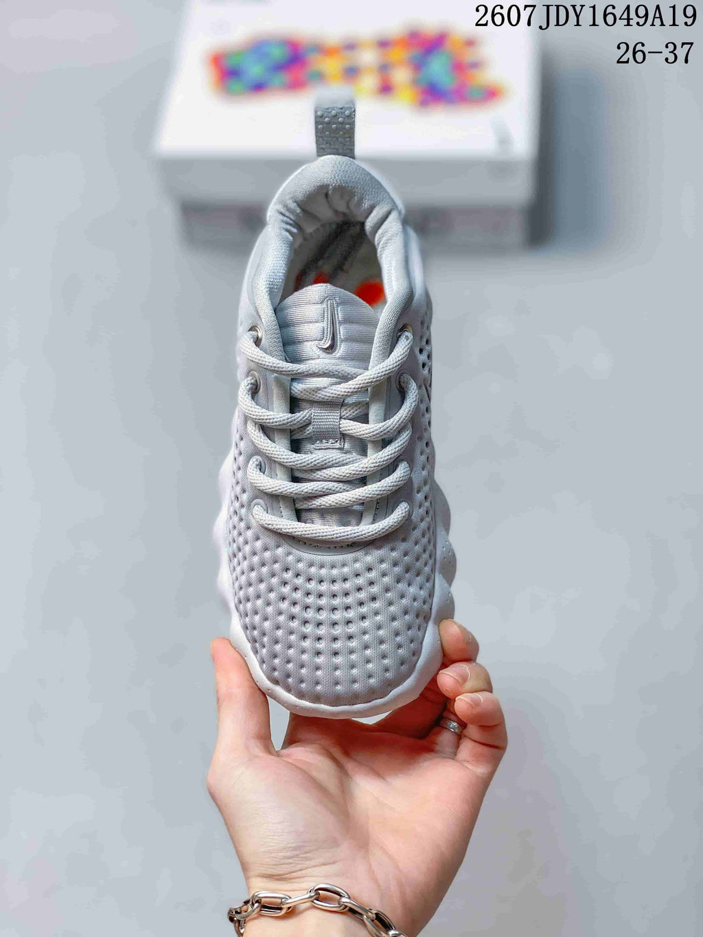 Front view of a Nike Mind 002 sneaker showing the perforated toe box, laces, padded tongue, and heel pull tab.