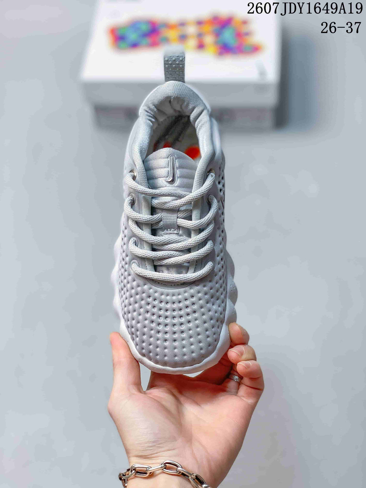 Front view of a Nike Mind 002 sneaker showing the perforated toe box, laces, padded tongue, and heel pull tab.
