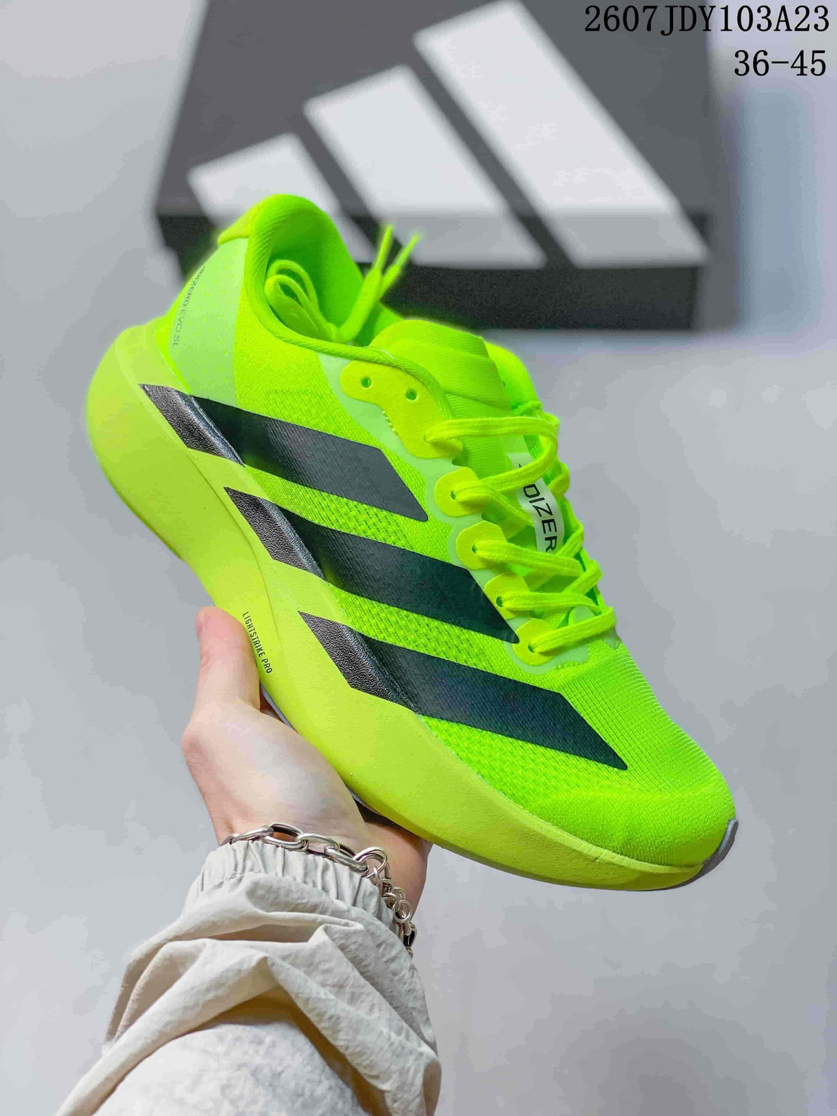 Neon green adidas Adizero low-top sneaker with black side stripes.