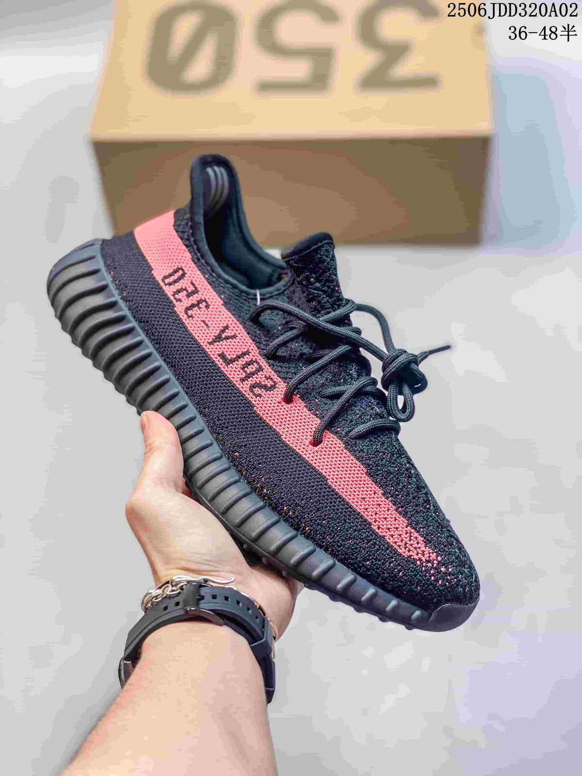 Black knit sneaker with a pink side stripe, black laces, and a ribbed black sole; box marking shows style code 2506JDD320A02 and size range 36–48.5.